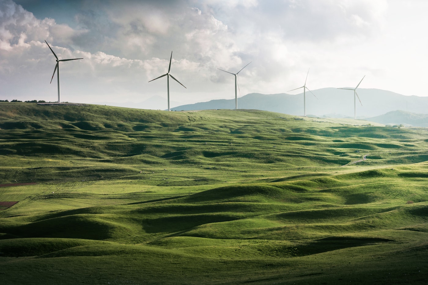 Wind turbines on green hills — sustainable environment